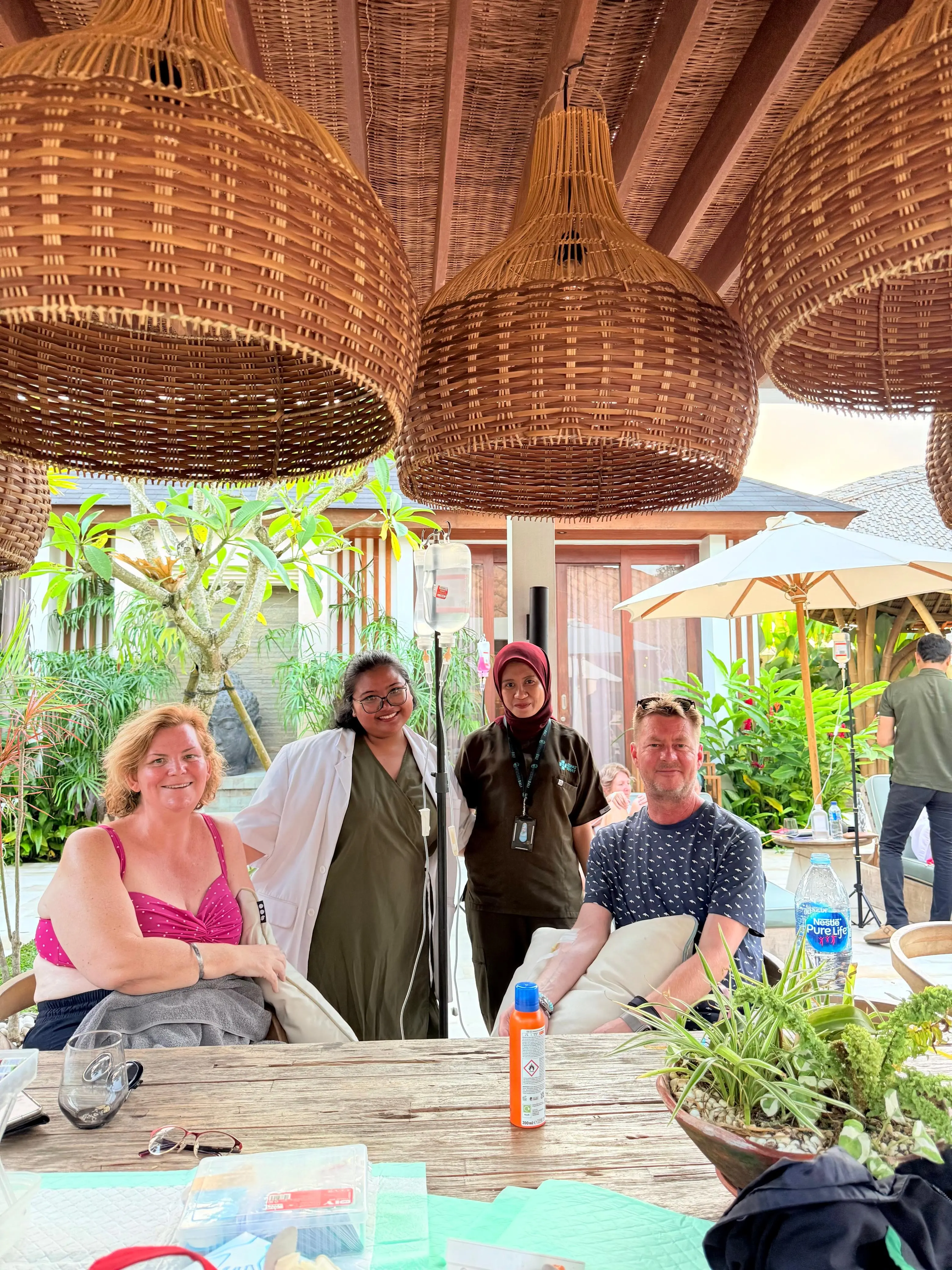 a family having iv drips by the pool side